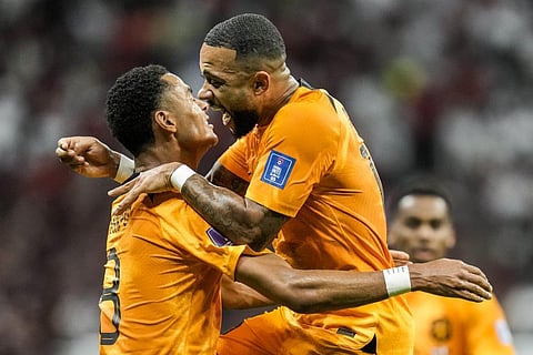 Cody Gakpo of the Netherlands, left, celebrates after scoring his side's opening goal during the World Cup group A match against Qatar, at the Al Bayt Stadium in Al Khor, Nov. 29, 2022. (Photo | AP)