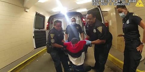 Richard 'Randy' Cox, center, is pulled from the back of a police van and placed in a wheelchair after being detained by New Haven Police. (Photo | AP)