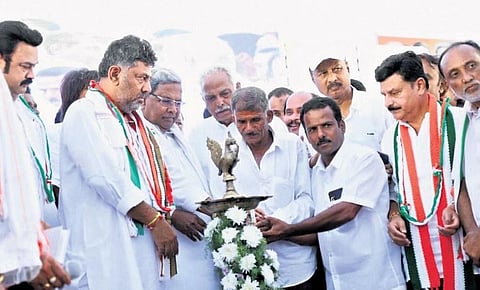 Leader of the Opposition Siddaramaiah, KPCC President DK Shivakumar, and other party leaders light a lamp during a Janakrosha meeting with Sharavathi evacuees in Shivamogga on Monday