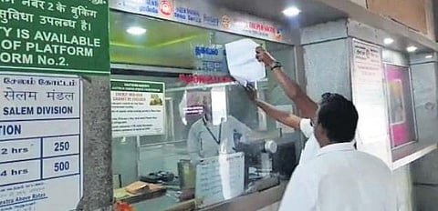 Workers remove the display board at Tiruppur railway station on Tuesday | Express