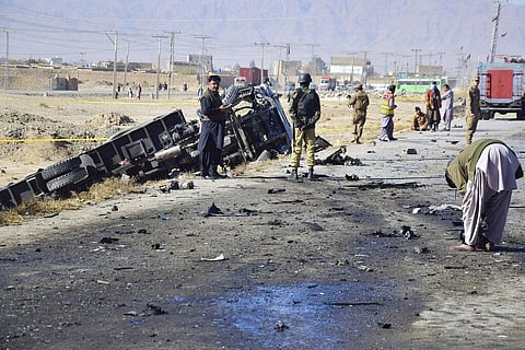 Investigators collect evidence at the site of a suicide bombing on the outskirt of Quetta, Pakistan, on November 30, 2022. (Photo | AP)