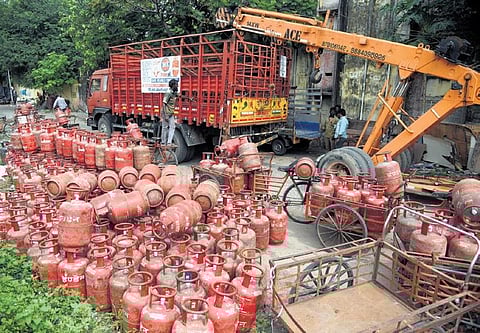 Truck laden with cylinders overturns