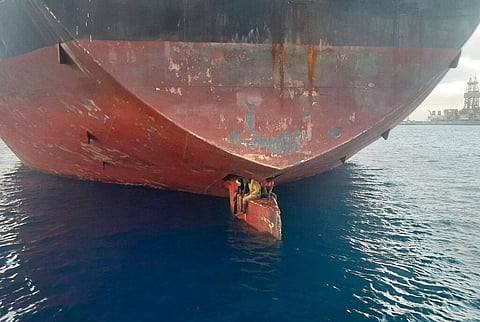 In this photo released by Spain's Maritime Safety and Rescue Society on Tuesday Nov. 29, 2022, three men are photographed on an oil tanker anchored in the port of the Canary Islands, Spain.