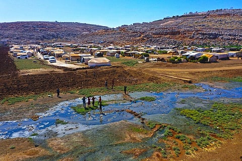 Children play near open sewage in the Salaheddine camp in northwestern Syria, Sept. 28, 2022. ( File Photo | AP)