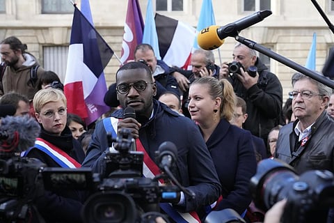Carlos Martens Bilongo speaks while lawmakers Mathilde Panot, second right, Clementine Autain, left, and far-left leader Jean-Luc Melenchon listen during the rally on Nov. 4, 2022. (Photo | AP)
