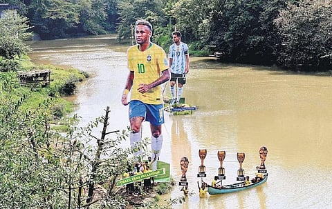 Cutouts of footballers Neymar and Lionel Messi erected in the middle of Cherupuzha river at Kurungattu Kadavu in Kozhikode. | E Gokul