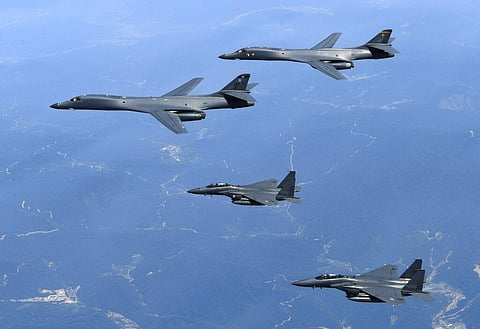 U.S. Air Force B-1B bombers, top, and second from top, and South Korean fighter jets F-15K fly over the Korean Peninsula (File photo | AP)