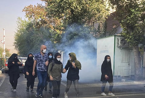 Tear gas is fired by security to disperse protestors in front of the Tehran University. (Photo | AP)
