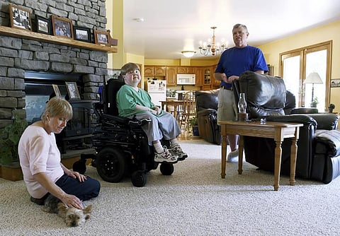 This undated photo shows Terry Horgan with his parents in the family's Montour Falls, N.Y., home. (Photo | The Journal via AP)