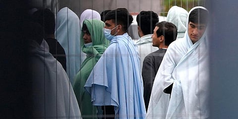 Migrants inside the Manston immigration short-term holding facility located at the former Defence Fire Training and Development Centre in Thanet, England. (Photo | AP)
