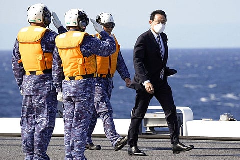 Japanese Prime Minister Fumio Kishida walks on the Maritime Self Defense Force's helicopter carrier JS Izumo during an international fleet review in Sagami Bay, southwest of Tokyo. (Photo | AP)