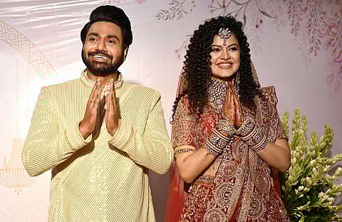 Singer Palak Muchhal with her husband and composer Mithoon Sharma greets during their wedding reception, in Mumbai on Sunday. (Photo | ANI)