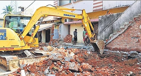 Houses and shops on the Jharigaon road being demolished I EXPRESS