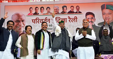 Congress National President Mallikarjun Kharge holds a sword during a rally at Banuti in Shimla Rural constituency. (Photo | ANI)