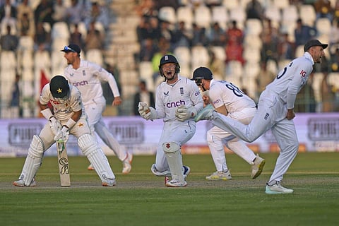 England players celebrate the dismissal of Pakistan's Imam-ul-Haq, (L), during the third day of the second test match in Multan, Dec. 11, 2022. (Photo | AP)