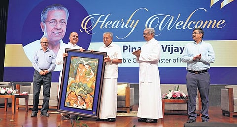 Fr Benny Nalkara CMI, provincial of the Sacred Heart province, presenting a memento to Chief Minister Pinarayi Vijayan on Saturday | express