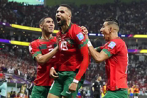 Morocco's Youssef En-Nesyri, center, celebrates after scoring his side's goal against Portugal during the World Cup quarterfinal match at Al Thumama Stadium in Doha, Dec. 10, 2022. (Photo | AP)