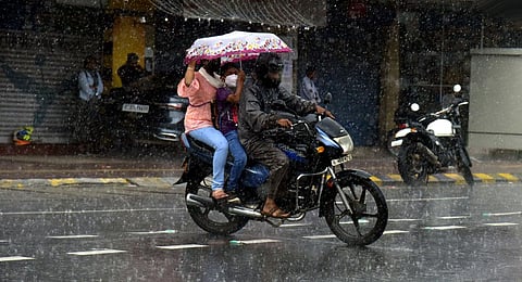 A family on a two-wheeler caught in the heavy rain that lashed Kochi on Sunday. (Photo | A Sanesh, EPS)