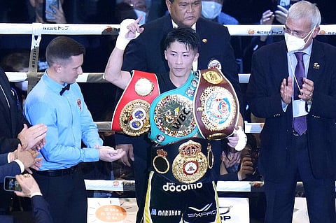Naoya Inoue of Japan celebrates after defeating Britain's Paul Butler after their bantamweight title unification boxing match of WBA, WBC, IBF, and WBO in Tokyo, Dec. 13, 2022.(Photo | AP)