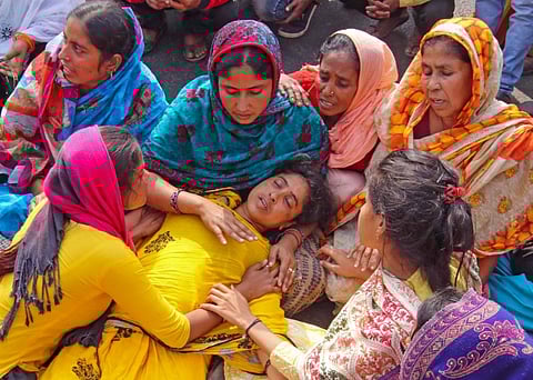 Reshma Bibi, wife of Lalan Sheikh, fainted during a protest outside the camp office of CBI, in Birbhum. (Photo | PTI)