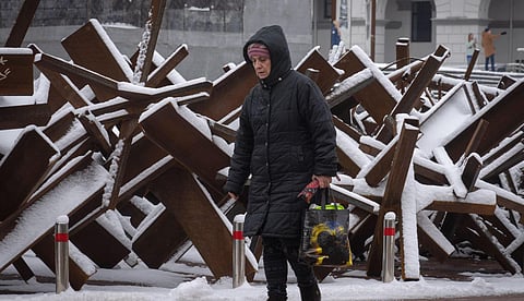 A woman passes by anti-tank hedgehogs in central Kyiv, Ukraine. Ukraine has been fighting with the Russian invaders since Feb. 24 for over nine months. (Photo | AP)