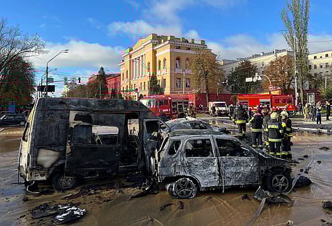 Rescue workers survey the scene of a Russian attack on Kyiv, Ukraine. (Photo | AP)