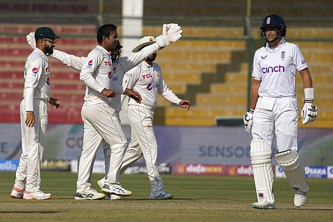 Pakistan's Nauman Ali celebrates with teammates after taking the wicket of England's Joe Root during the second day of third test cricket match between England and Pakistan. (Photo | AP)