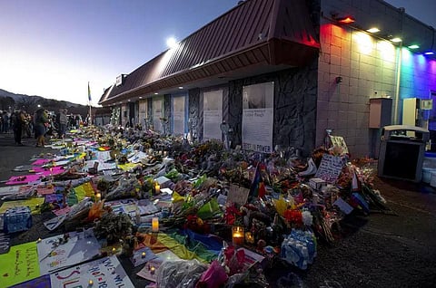 Mourners gather outside Club Q to visit a memorial, which has been moved from a sidewalk outside of police tape that was surrounding the club, November 25, 2022, in Colorado Spring. (File Photo | AP)