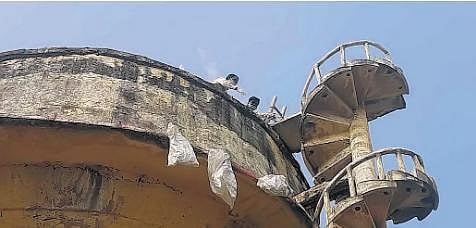 ​  The carcasses of the monkeys being dropped in packed bags from the overhead tank at Halakarta village in Kalaburagi district  ​
