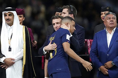 France's President Emmanuel Macron embraces Kylian Mbappe at the end of the World Cup final soccer match between Argentina and France. (Photo | AP)
