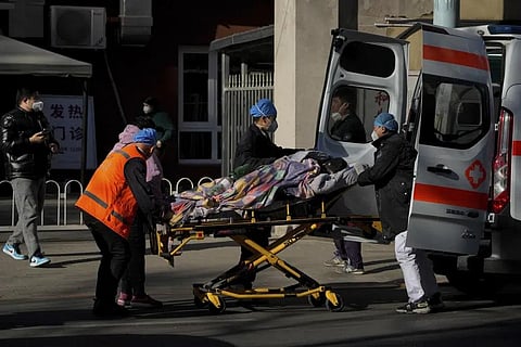 A patient is wheeled into the fever clinic at a hospital in Beijing, Monday, Dec. 19, 2022. (Photo | AP)