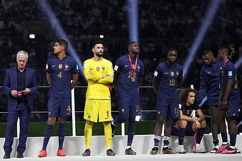 France's head coach Didier Deschamps, left, and his players react after receiving their second place medals at the end of the World Cup final soccer match at the Lusail Stadium in Lusail, Qatar | AP
