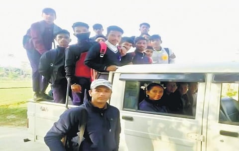 An armed forest personnel with schoolkids near Corbett on Sunday. (Photo | Express)