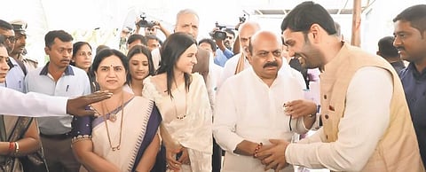 Chief Minister Basavaraj Bommai greets Vivek Hebbar, son of Labour Minister Shivaram Hebbar on Sunday | Express