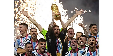 Argentina's Lionel Messi lifts the trophy after winning the World Cup final soccer match between Argentina and France at the Lusail Stadium, Dec. 18, 2022. (Photo | AP)