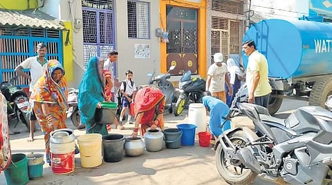 Residents waiting in a queue to collect water from a tanker | Express