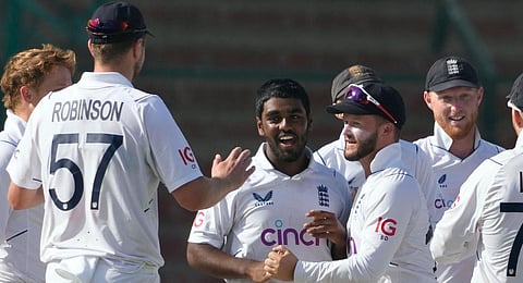 England's Rehan Ahmed, center, celebrates with teammates after taking the wicket of Pakistan's Saud Shakeel. (Photo | PTI)