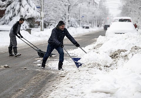 Vancouver International Airport temporarily suspended all incoming and outgoing flights early Tuesday, holding departing aircraft at their gates and stranding passengers aboard some arriving flights for hours. Residents use sleigh shovels to dig out their driveways after a snowplow passed, after a snowstorm in Ottawa. (Photo | AP)