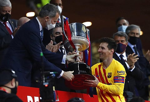 Barcelona's Lionel Messi receives the trophy by Spain's King Felipe after winning the Spanish Copa del Rey final 2021 against Athletic Bilbao. (File photo | AP)