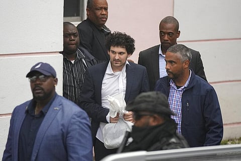 FTX founder Sam Bankman-Fried, center, is escorted from the Magistrate Court in Nassau, Bahamas, Wednesday, Dec. 21, 2022, after agreeing to be extradited to the U.S. (Photo | AP)