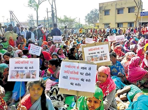 Tribals protest against the attack on minorities on Wednesday. (Photo | Express)