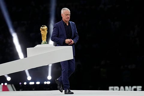 France's head coach Didier Deschamps walks past the Word Cup trophy after receiving his second place medal at the end of the final between Argentina and France at the Lusail Stadium. (Photo | AP)