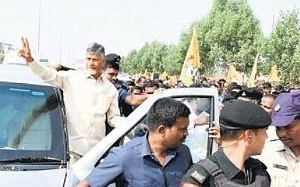 TDP chief N Chandrababu Naidu gestures while on his way to address a public meeting in Khammam on Wednesday