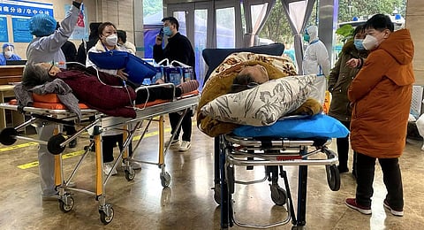 This picture shows Covid-19 patients on stretchers in the emergency ward of the First Affiliated Hospital of Chongqing Medical University in China's southwestern city of Chongqing. (Photo | AFP)