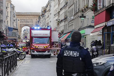 A police officer stands next to the cordoned off area where a shooting took place in Paris, Friday, Dec. 23, 2022. (Photo | AP)