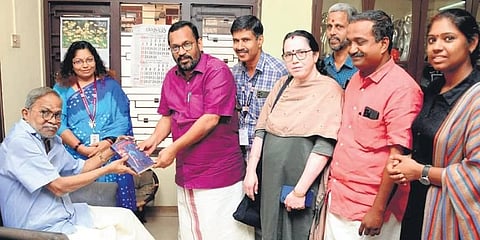Writer M T Vasudevan Nair handing over the books to Revenue Minister K Rajan at the former’s residence in Kozhikode on Friday | Express