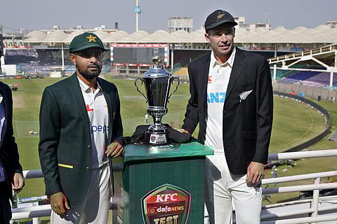 Pakistani skipper Babar Azam, (L), and his New Zealand's counterpart Tim Southee pose for a photo with the test series trophy, in Karachi, Pakistan,  Dec. 25, 2022. (Photo | AP)