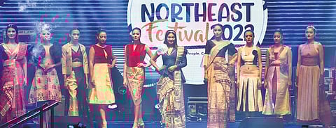 Models showcasing traditional attire on the runway;