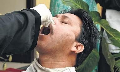 A health worker collects a man’s swab sample at the Urban Primary Health Centre in Cubbonpet, Bengaluru, on  Monday | Shashidhar Byrappa