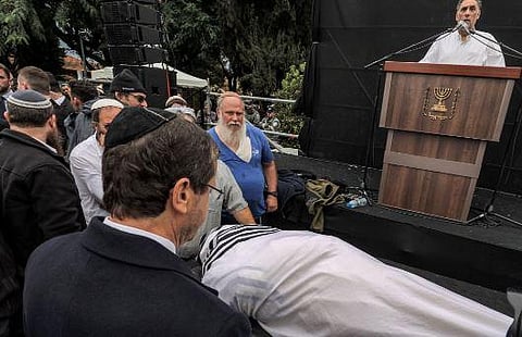 Israel's President Isaac Herzog (L) reacts by the body of Israeli Orthodox Jewish rabbi Haim Drukman, a spiritual leader of the nationalist Religious Orthodox Jewish movement. (Photo | AFP)